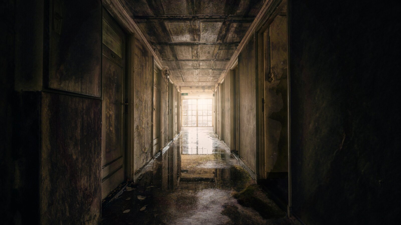 A dim corridor lit by candlelight