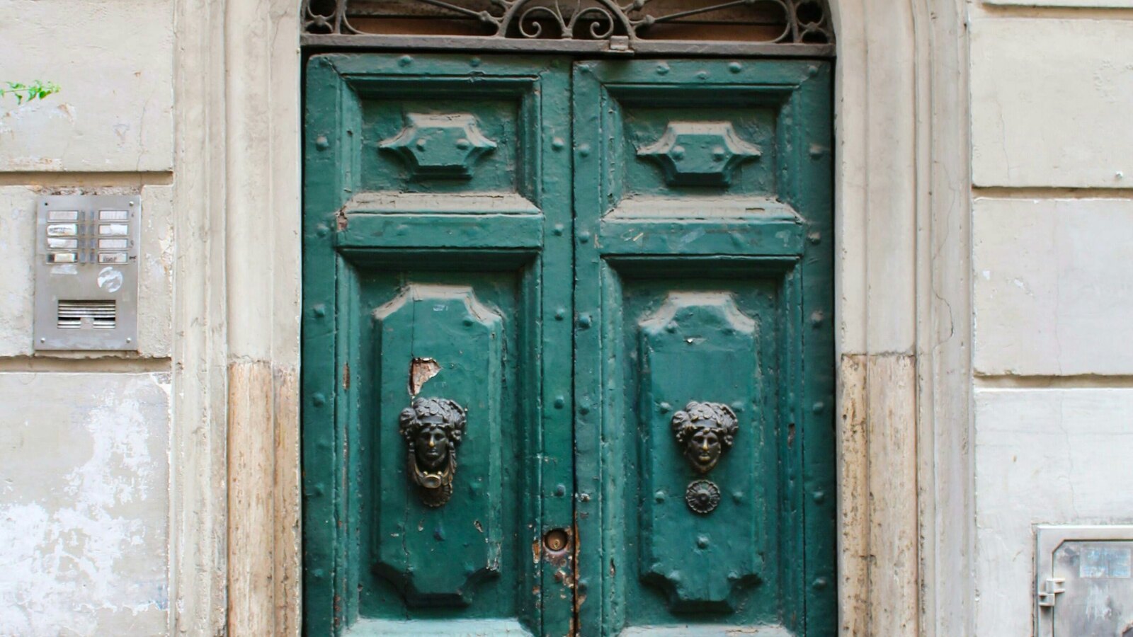 A vintage brass door knocker on an old building